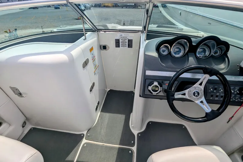 Slide: The Image of 2011 Sea Ray 260 Sundeck cockpit with steering wheel and instrument panel. - 4