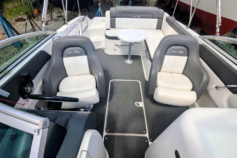 Slide: The Image of 2011 Sea Ray 260 Sundeck interior with seating and table, showcasing luxury boat design. - 6