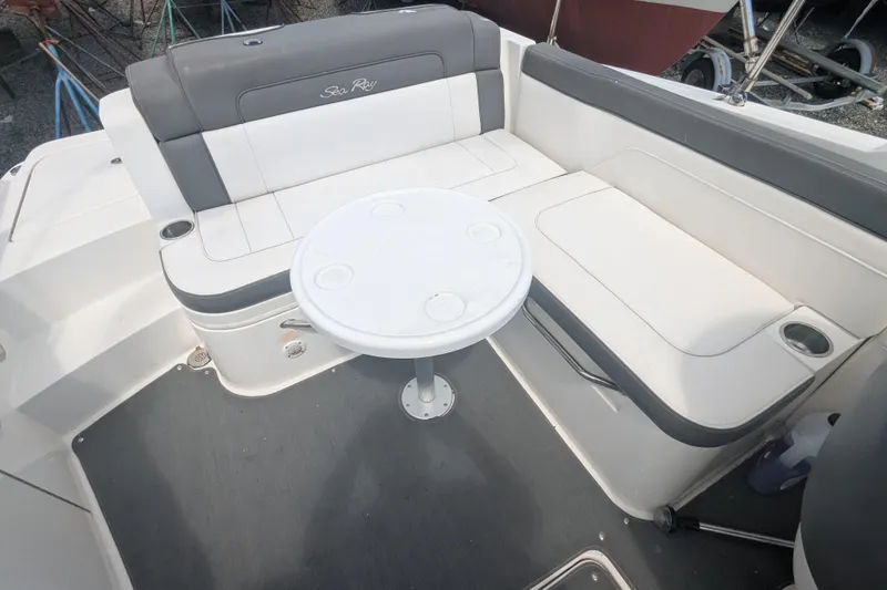 Slide: The Image of 2011 Sea Ray 260 Sundeck interior with seating and round table. - 7