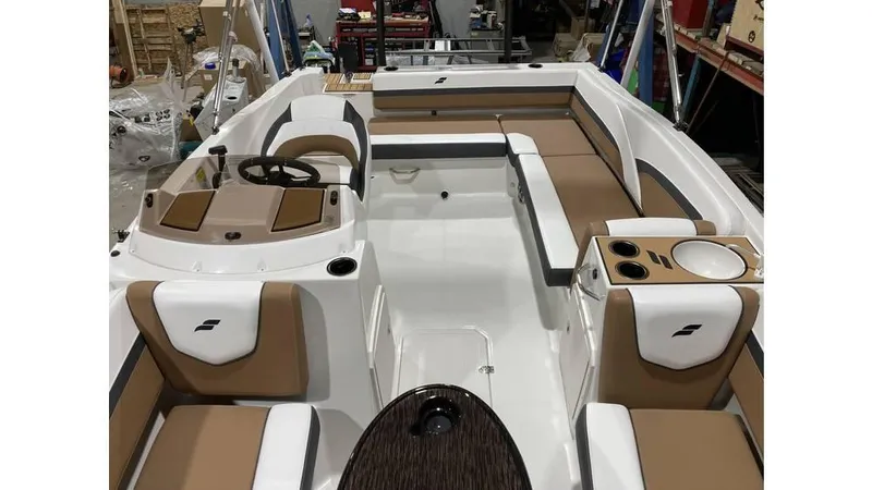 Slide: The Image of 2025 Starcraft SVX 191 OB boat interior with tan and white seating, steering wheel, and cup holders. - 7