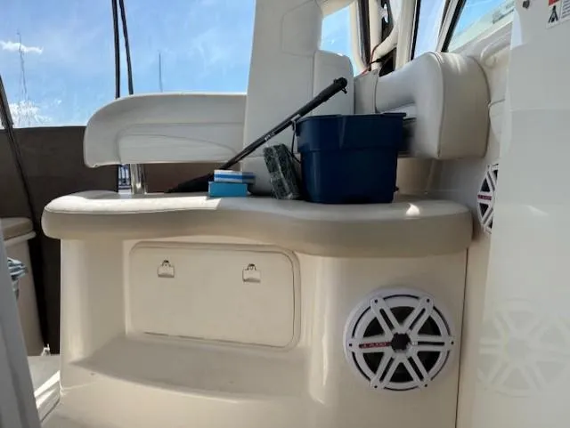 Slide: The Image of 2015 Wellcraft 290 Coastal boat interior with seating, storage, and marine speakers. - 13