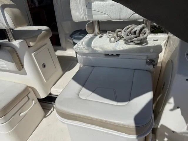 Slide: The Image of 2015 Wellcraft 290 Coastal boat interior with white seating and coiled rope. - 14
