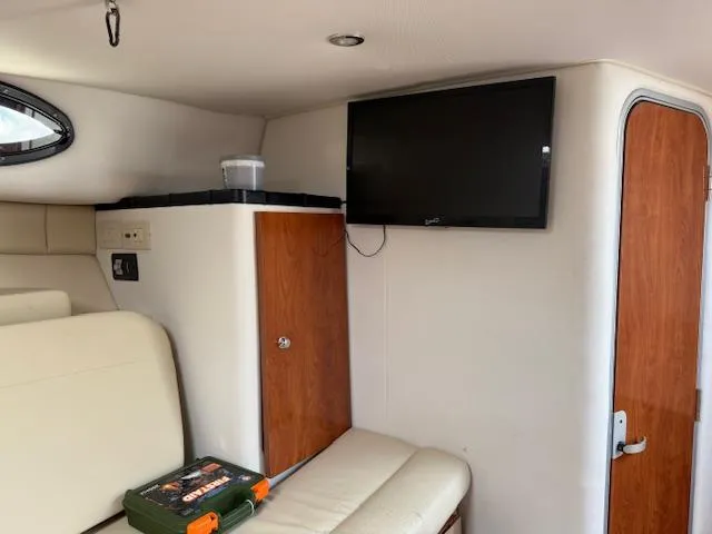 Slide: The Image of Interior of 2015 Wellcraft 290 Coastal boat with TV, seating, and storage cabinet. - 22