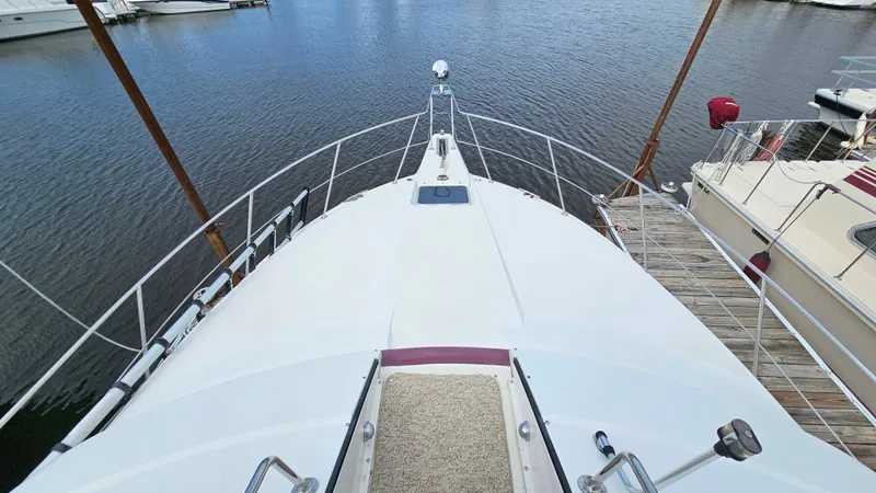 Slide: The Image of 1989 Carver 38 Santego yacht docked at marina, view from bow. - 14