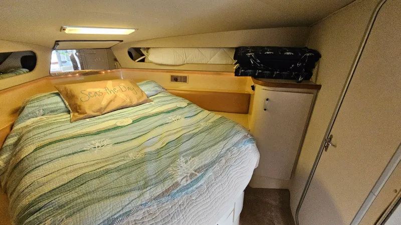 Slide: The Image of Cozy cabin interior of 1989 Carver 38 Santego with bed and storage. - 23