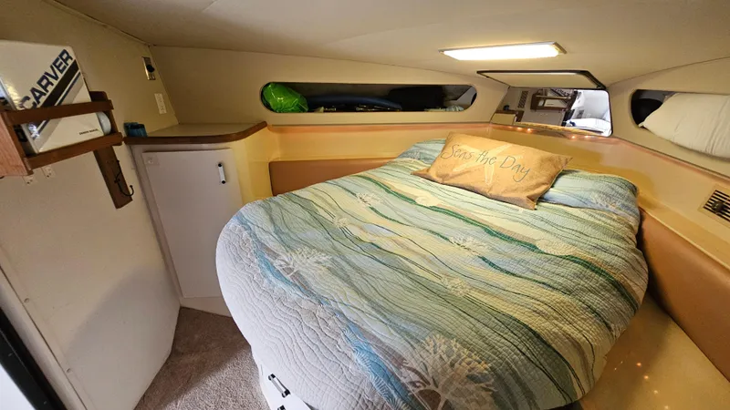 Slide: The Image of Cozy cabin interior of 1989 Carver 38 Santego with bed and decorative pillow. - 24