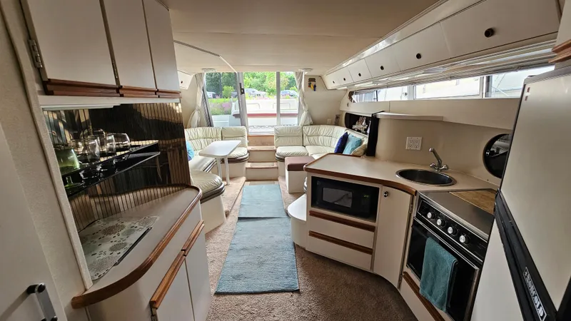 Slide: The Image of Interior of 1989 Carver 38 Santego yacht with kitchen and seating area. - 28