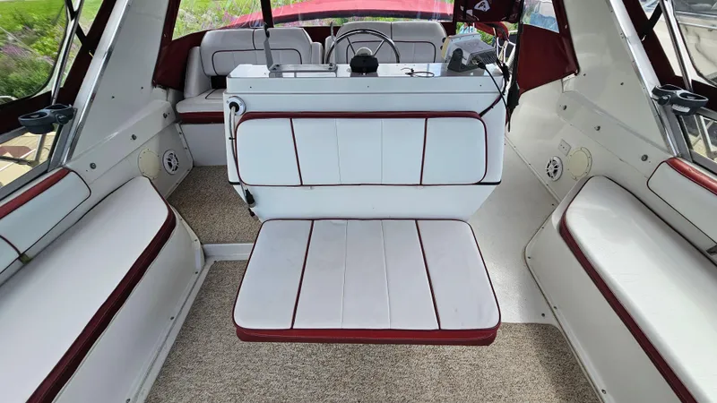 Slide: The Image of 1989 Carver 38 Santego boat interior with white and red seating, steering console. - 12
