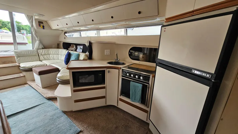 Slide: The Image of Interior of 1989 Carver 38 Santego yacht with kitchen and seating area. - 20