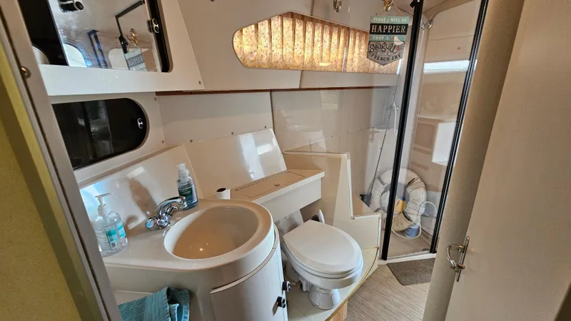 Slide: The Image of 1989 Carver 38 Santego boat bathroom with sink, toilet, and shower area. - 25