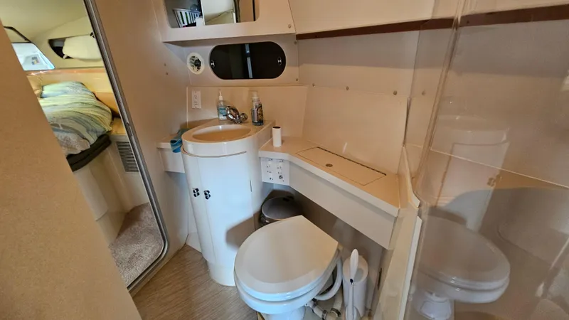 Slide: The Image of 1989 Carver 38 Santego yacht bathroom with sink, toilet, and mirror. - 26