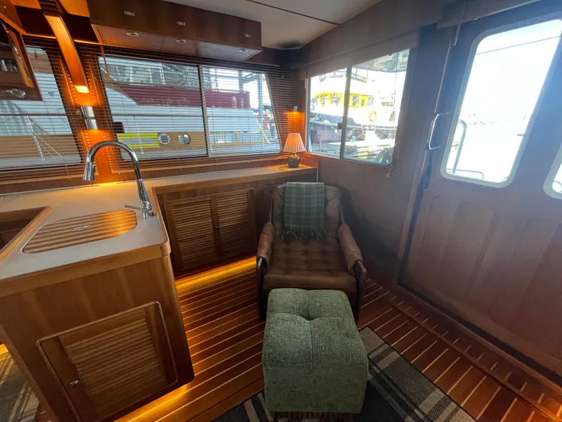 Slide: The Image of Luxurious interior of 2025 Helmsman Trawlers 43E Pilothouse with cozy seating and elegant wood finishes. - 12