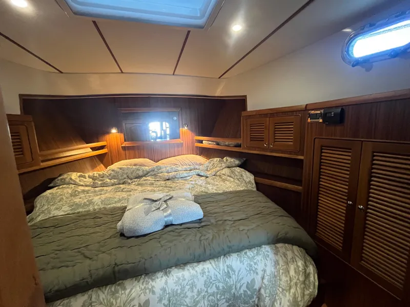 Slide: The Image of Luxurious cabin interior of 2025 Helmsman Trawlers 43E Pilothouse with cozy bedding. - 17