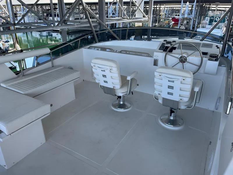 Slide: The Image of Helmsman Trawlers 43E Pilothouse 2025, featuring a spacious helm with seating and steering wheel. - 31