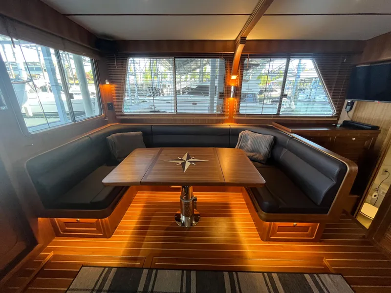 Slide: The Image of Luxurious interior of 2025 Helmsman Trawlers 43E Pilothouse with elegant wood finish and seating. - 4