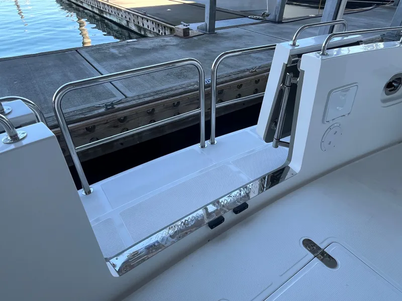 Slide: The Image of Helmsman Trawlers 43E PILOTHOUSE 2025 yacht deck with open gate at dock. - 41