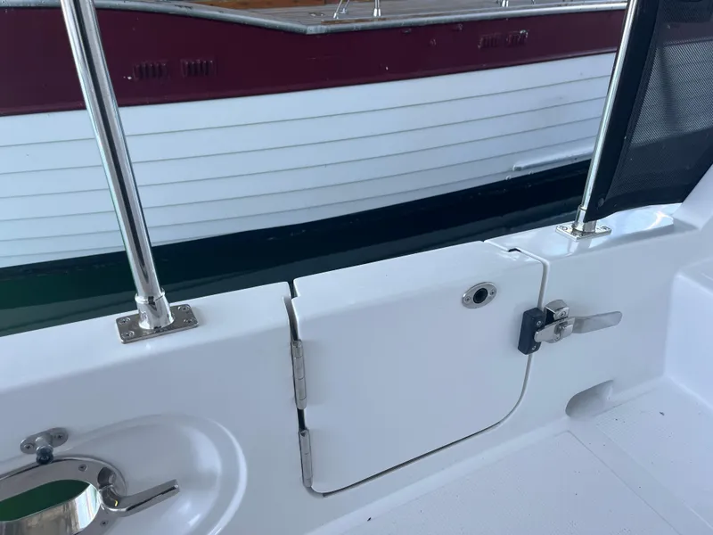 Slide: The Image of Helmsman Trawlers 43E Pilothouse 2025, deck view with railing and hatch. - 43