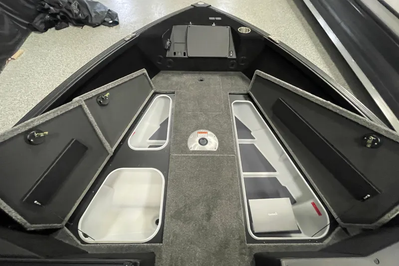Slide: The Image of 2026 Alumacraft Competitor 195X Sport boat interior with open storage compartments. - 10