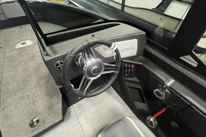 Slide: The Image of 2026 Alumacraft Competitor 195X Sport boat interior with steering wheel and Garmin navigation system. - 11