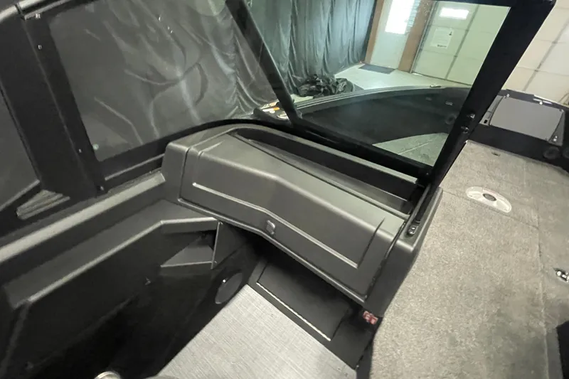 Slide: The Image of 2026 Alumacraft Competitor 195X Sport interior with open windshield and carpeted flooring. - 13
