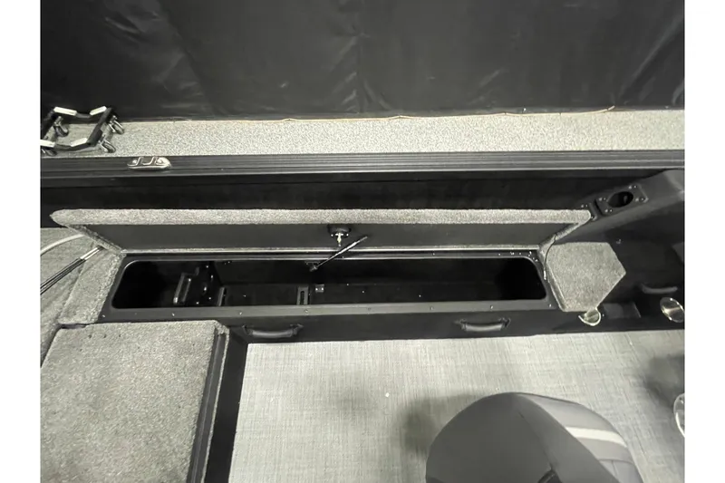 Slide: The Image of 2026 Alumacraft Competitor 195X Sport boat interior storage compartment. - 15
