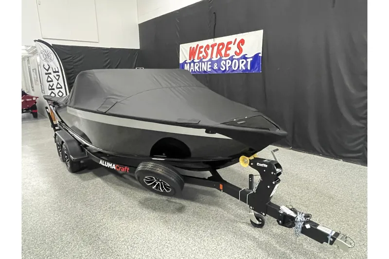 Slide: The Image of 2026 Alumacraft Competitor 195X Sport boat covered on trailer at Westre's Marine & Sport. - 17