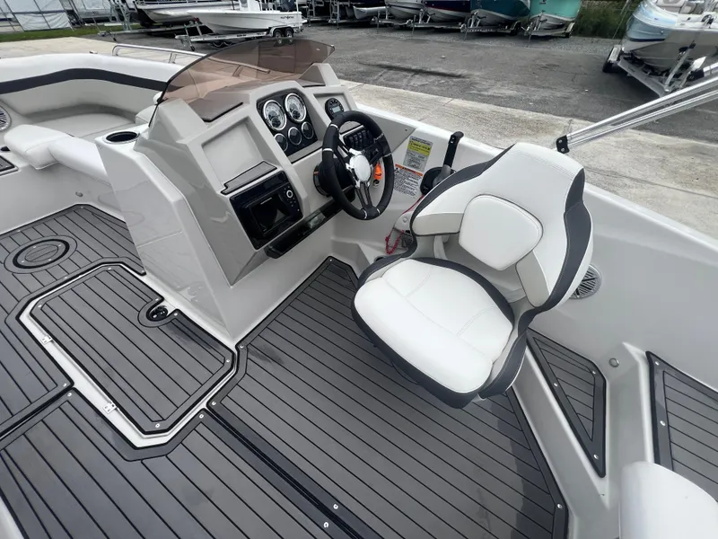 Slide: The Image of 2022 Starcraft SVX 191 OB boat interior with steering console and white captain's chair. - 15