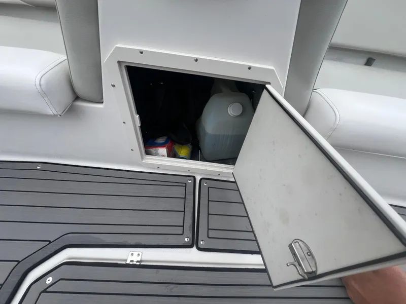 Slide: The Image of Storage compartment on a 2022 Starcraft SVX 191 OB boat, open with items inside. - 21