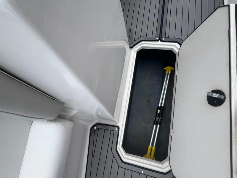 Slide: The Image of Open storage compartment on 2022 Starcraft SVX 191 OB boat with paddle inside. - 22