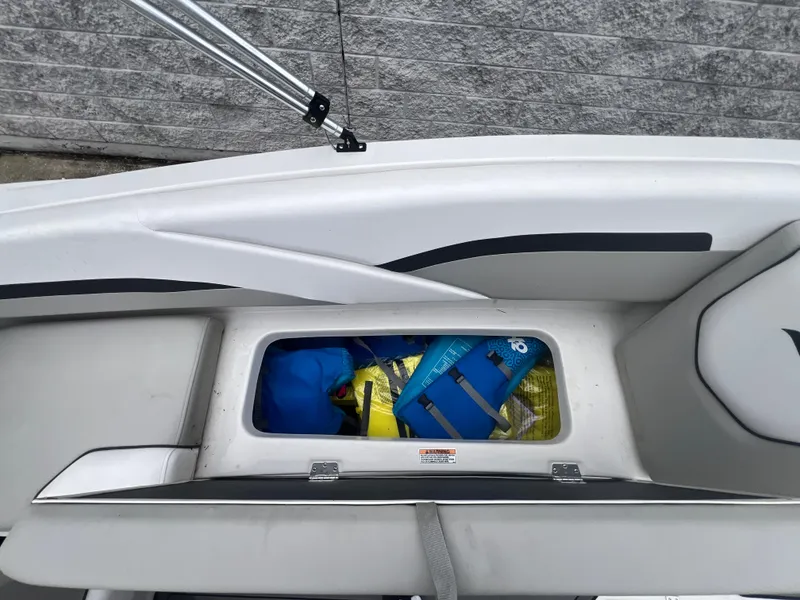 Slide: The Image of Storage compartment of 2022 Starcraft SVX 191 OB boat with life jackets inside. - 23