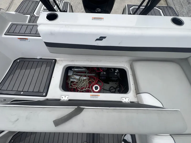 Slide: The Image of 2022 Starcraft SVX 191 OB boat storage compartment with ropes and battery visible. - 24