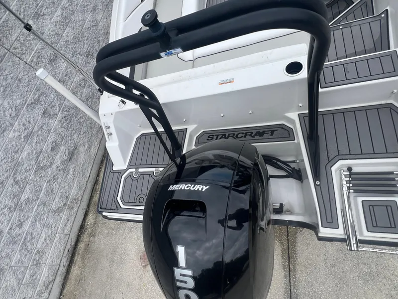 Slide: The Image of 2022 Starcraft SVX 191 OB boat with Mercury 150 outboard motor, docked on textured surface. - 5
