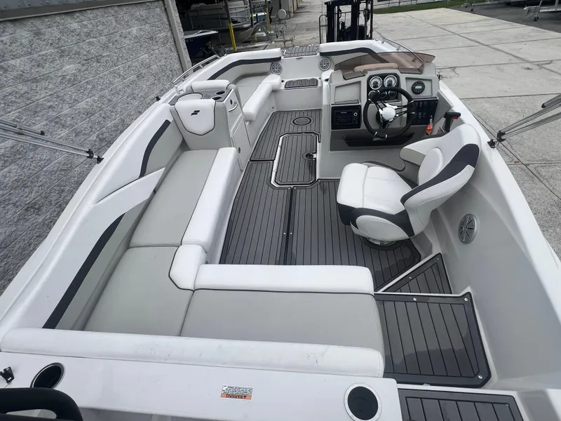 Slide: The Image of 2022 Starcraft SVX 191 OB boat interior with seating and steering console. - 6