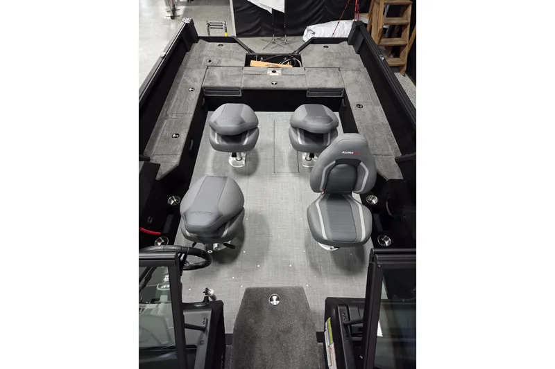 Slide: The Image of 2026 Alumacraft Competitor 195X Sport interior with four gray seats and spacious layout. - 5