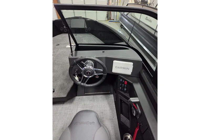Slide: The Image of 2026 Alumacraft Competitor 195X Sport boat interior with Garmin navigation system. - 6