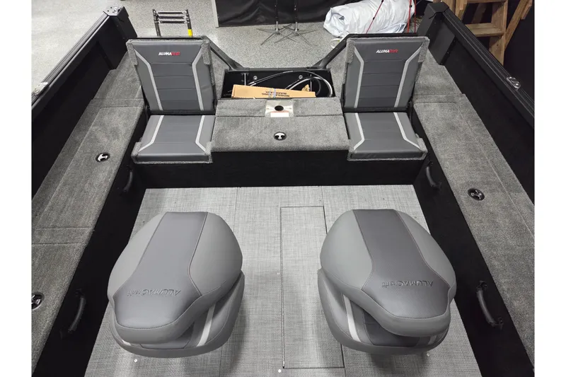 Slide: The Image of 2026 Alumacraft Competitor 195X Sport boat interior with gray seating and carpeted flooring. - 8
