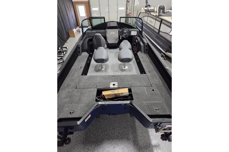 Slide: The Image of 2026 Alumacraft Competitor 195X Sport boat interior with seating and steering console. - 9