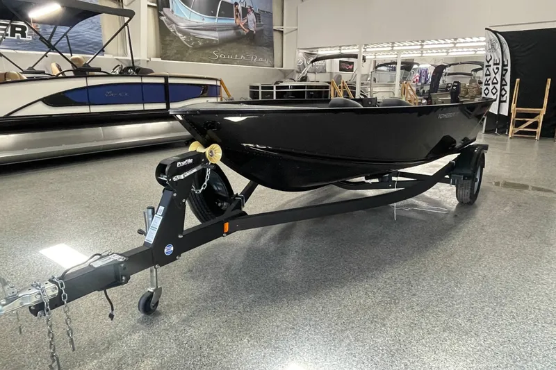Slide: The Image of 2026 Alumacraft Voyageur 175 Tiller boat on trailer in showroom. - 2