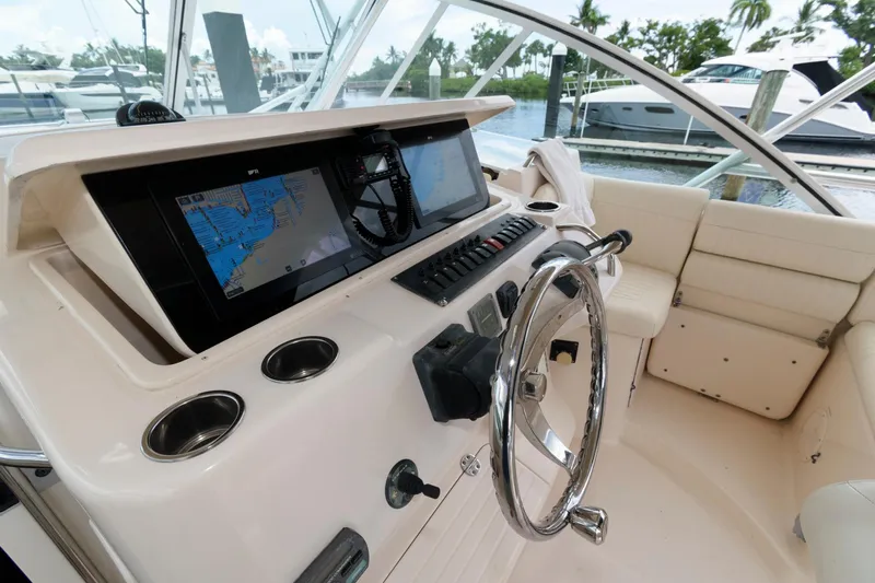 Slide: The Image of 2007 Grady-White Express 360 helm with navigation screens and steering wheel. - 12