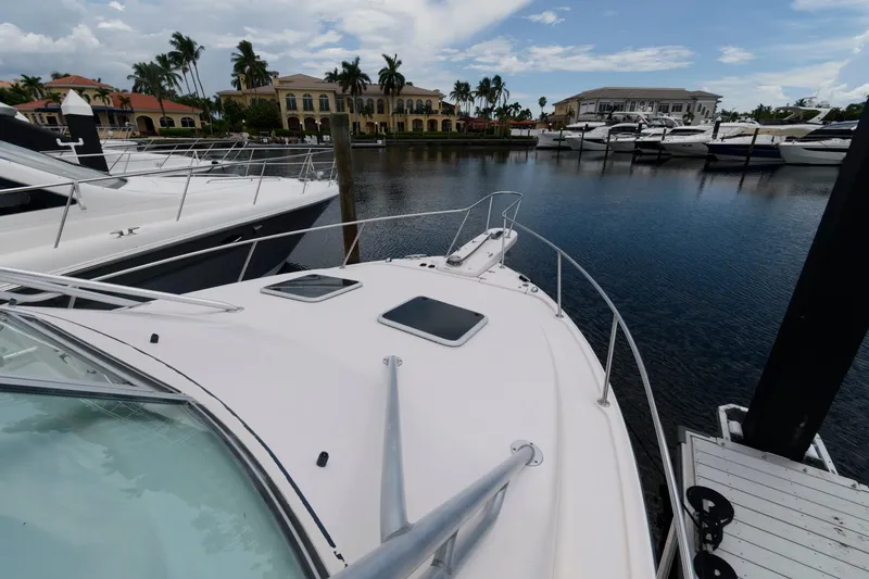 Slide: The Image of 2007 Grady-White Express 360 docked in a marina with luxury homes in the background. - 18