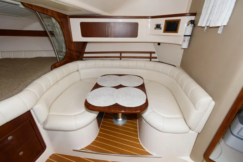 Slide: The Image of Luxurious 2007 Grady-White Express 360 cabin with elegant seating and wooden accents. - 21