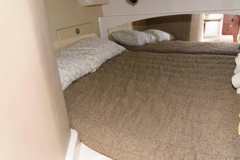 Slide: The Image of 2007 Grady-White Express 360 cabin interior with cozy bed and pillows. - 25