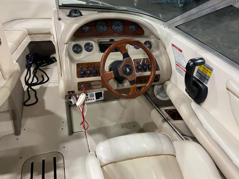 Slide: The Image of 1995 Sea Ray Signature Select boat interior with wood-accented steering wheel and control panel. - 13