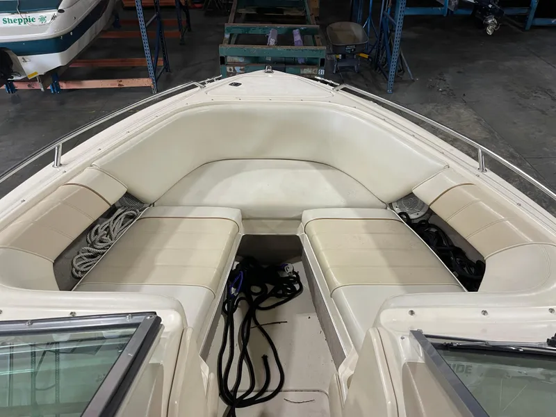 Slide: The Image of 1995 Sea Ray Signature Select boat interior with white seating and storage compartments. - 17