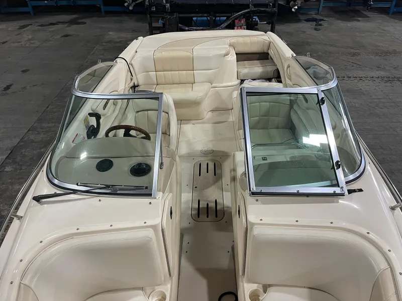 Slide: The Image of 1995 Sea Ray Signature Select boat interior with white seating and dual windshields. - 19