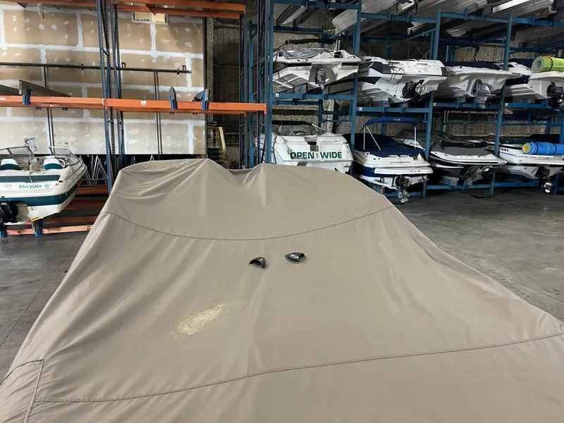 Slide: The Image of Covered 1995 Sea Ray Signature Select boat in indoor storage facility. - 23