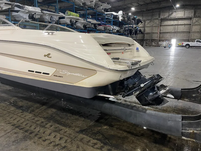 Slide: The Image of 1995 Sea Ray Signature Select boat in warehouse, showing rear view and engine. - 5