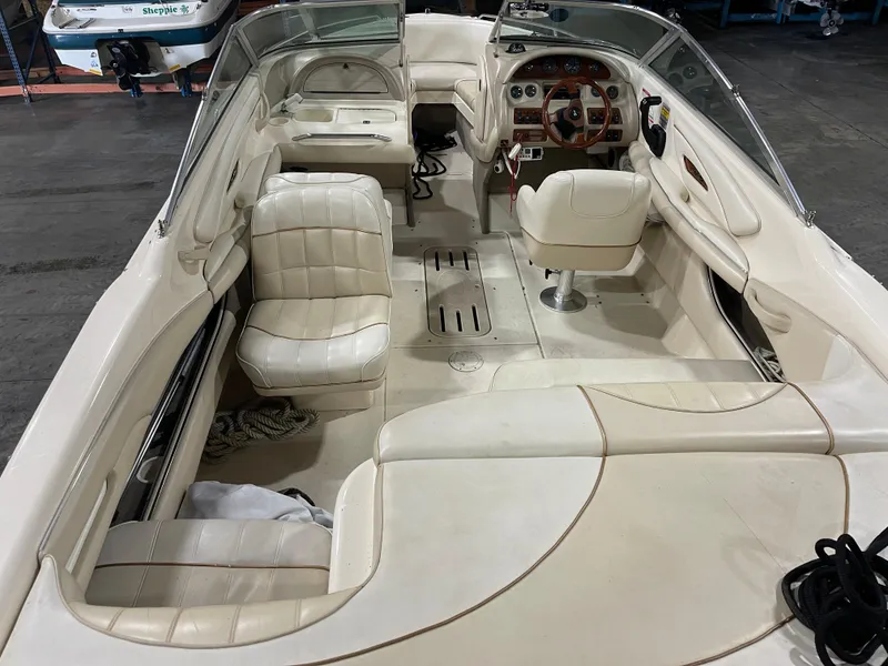 Slide: The Image of 1995 Sea Ray Signature Select boat interior with white leather seating and wooden steering wheel. - 8
