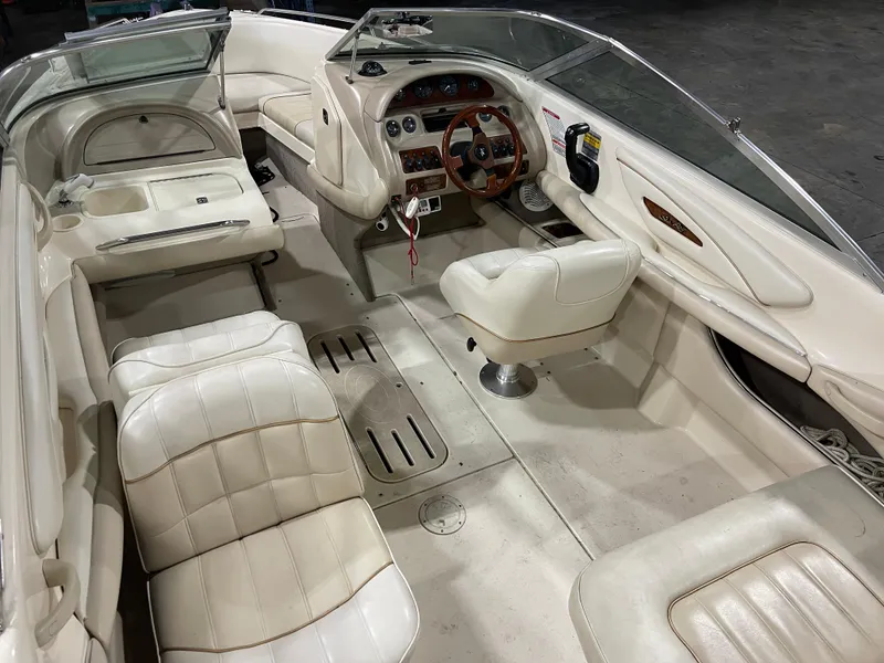 Slide: The Image of 1995 Sea Ray Signature Select boat interior with white leather seating and wooden steering wheel. - 9