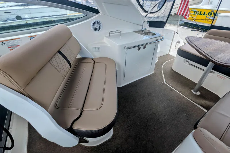 Slide: The Image of Interior of 2017 Sea Ray Sundancer 280 with seating, table, and kitchenette. - 14